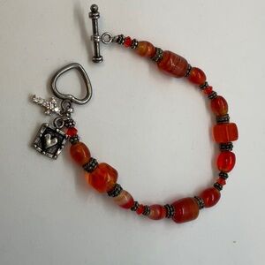 Orange glass and silver charm toggle clasp bracelet